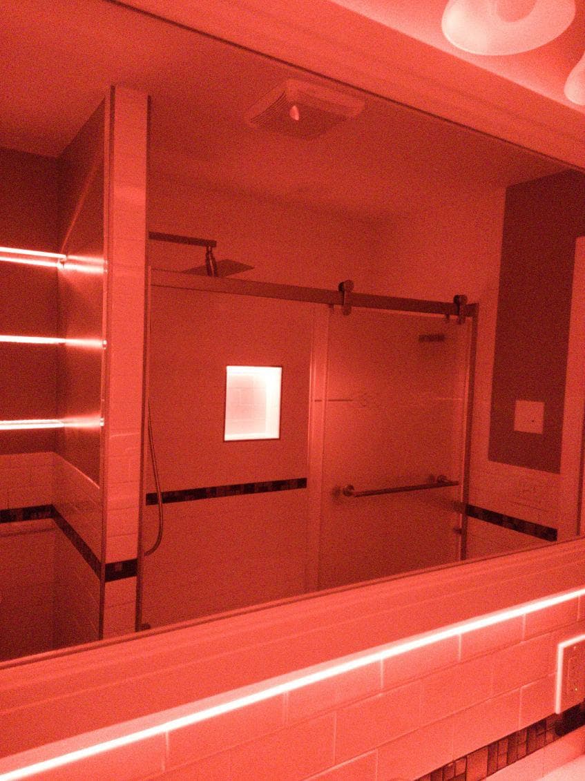 picture of newly remodeled bathroom with custom red led lighting 