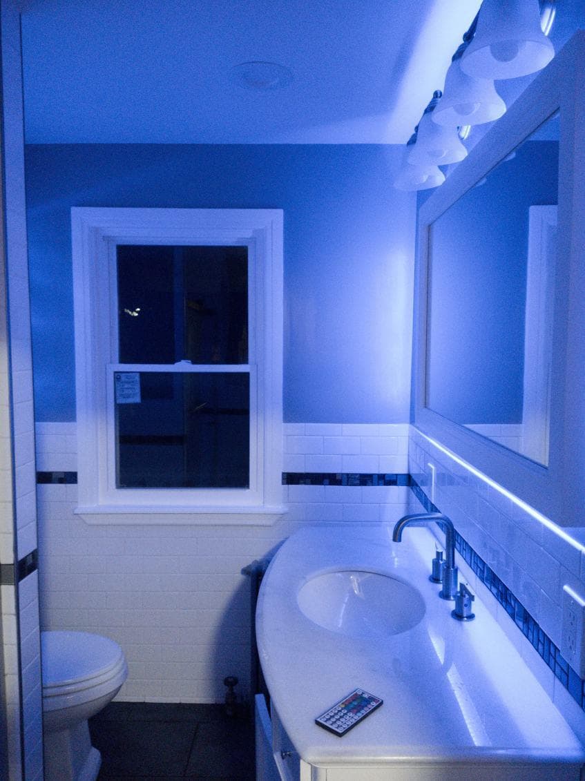 picture of a newly remodeled bathrrom with custom blue led lighting