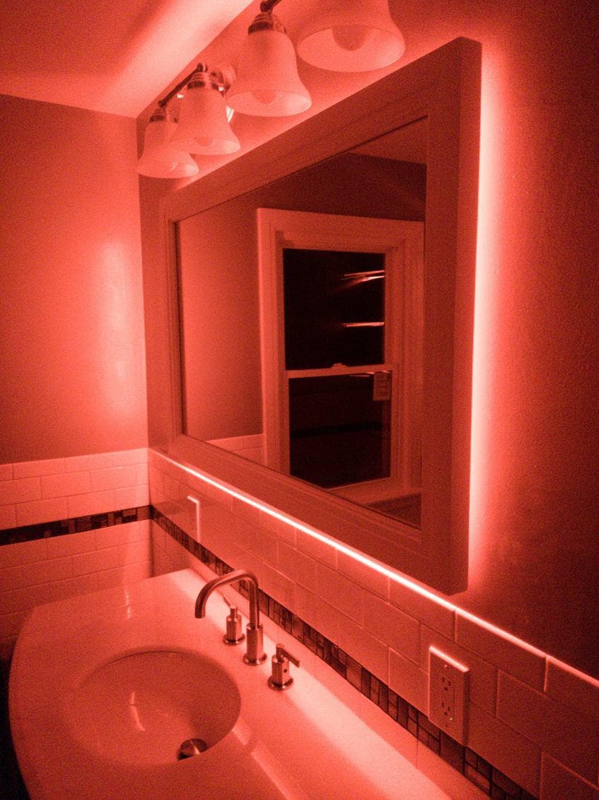 picture of a newly remodeled bathroom with custom red led lighting