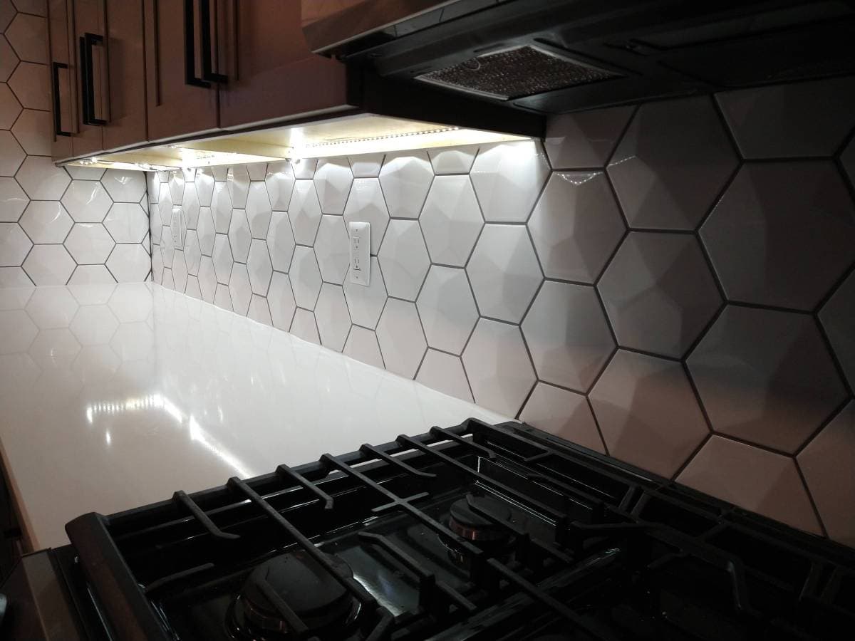 picture of a newly remodeled kitchen with a hexagon luxury backsplash